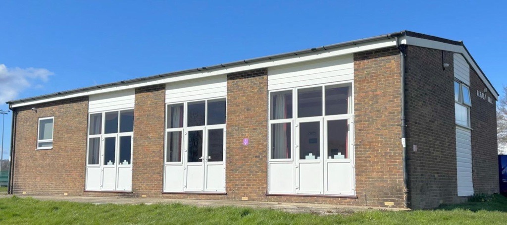 Exterior view of Alfold Village Hall on a clear day
